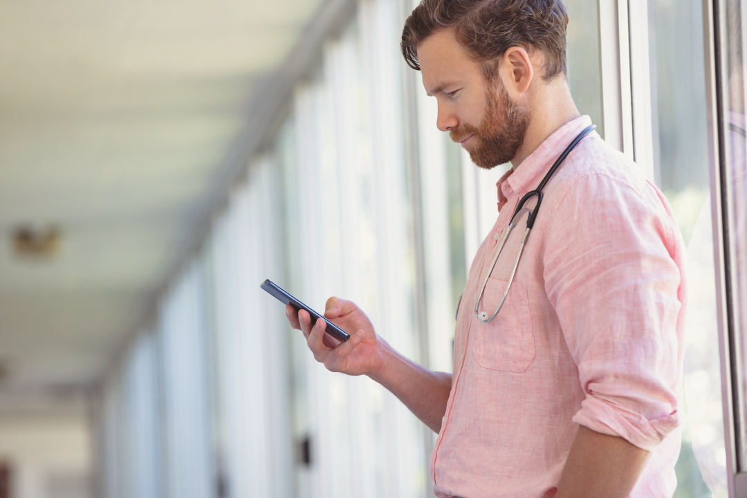 physician working on his smartphone between patients