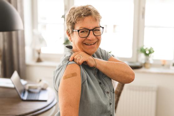 Middle aged female showing off her bandaid on her arm