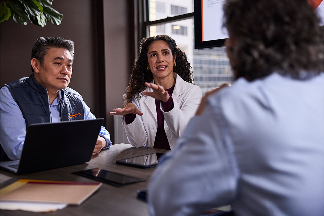 Researcher and Optum employees meeting 