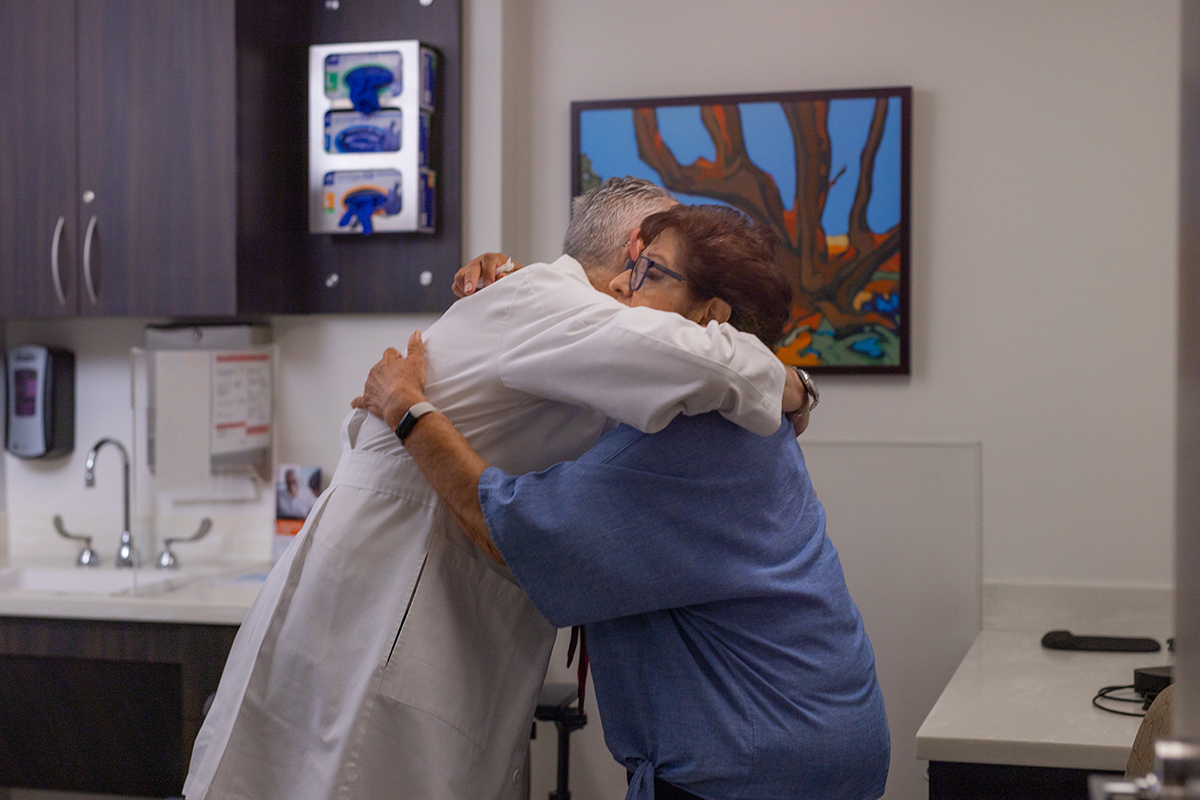 Patient hugging doctor