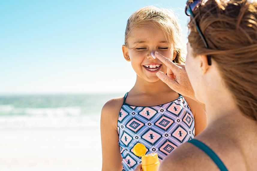 Mother applying sunscreen protection for her daughter