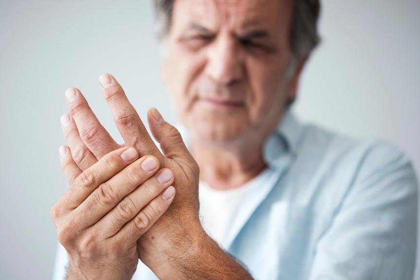 Person experiencing chronic pain in their hand