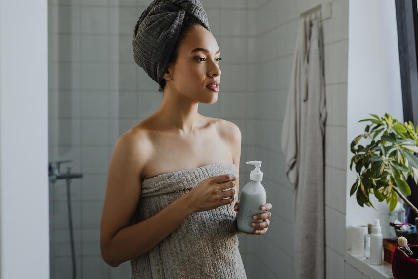 Woman using moisturizer for an article about caring for skin in winter