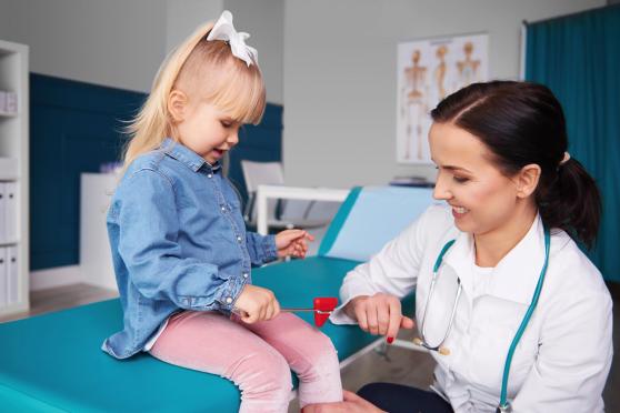 A healthy child getting a physical exam checkup at the doctor's office