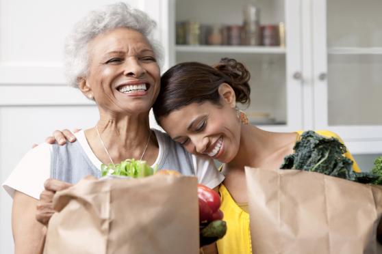 People smiling with bag of groceries for a story on heart health