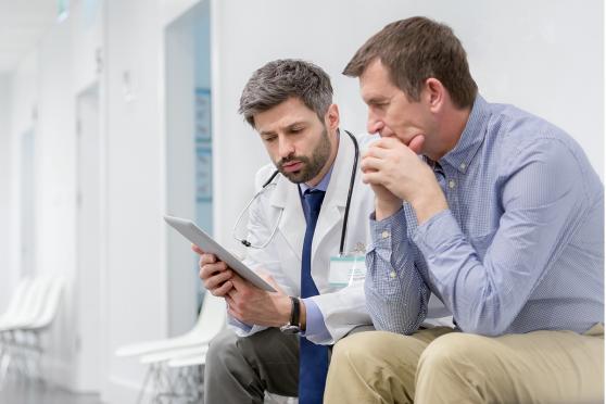 A man talking to the doctor about colon cancer screening