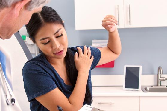 Woman at the doctor for shoulder pain