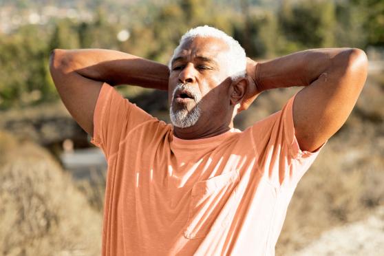 An older man taking a breath after exercising outside