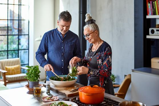 Man and woman in kitchen with plant foods