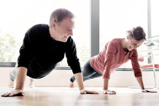 Couple doing pushups during a HIIT workout