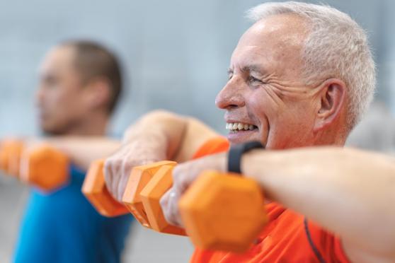 An older man exercising in a class