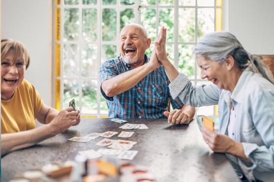 A group of older adults playing card games