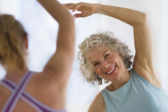 Senior woman with fitness instructor at gym recovering from heart attack