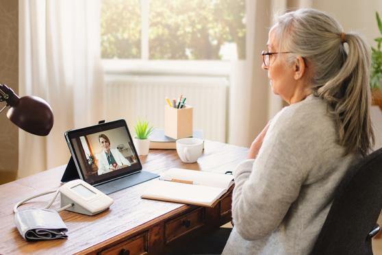 Senior women talking to virtual doctor on a tablet