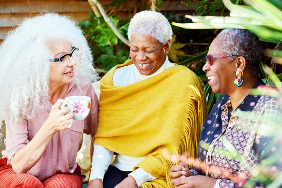 Three older women chatting for an article on being healthy after 60