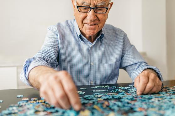 Man putting together a puzzle